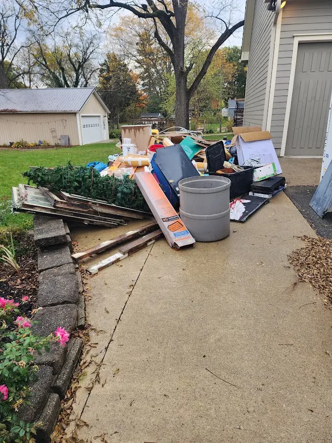 Dumpster being loaded with debris for 12 Yard Dumpster Rental in Day Valley